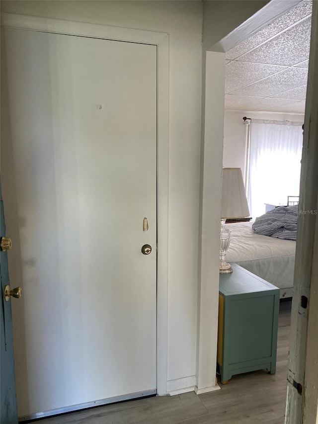 bedroom with hardwood / wood-style floors and a textured ceiling