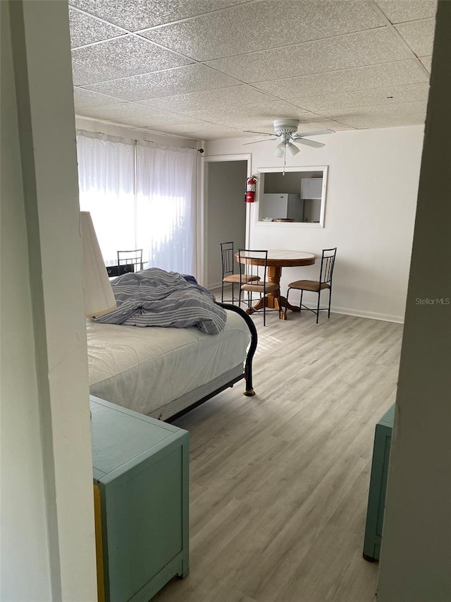 bedroom featuring wood-type flooring, ceiling fan, and a textured ceiling