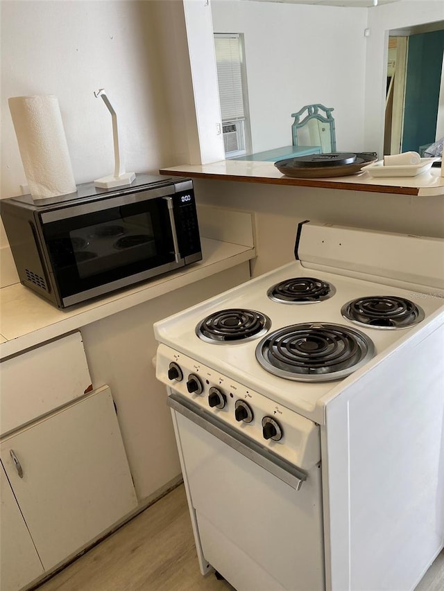 kitchen with light wood-type flooring and electric range