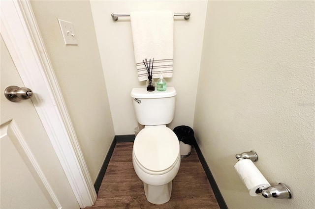 bathroom with hardwood / wood-style floors and toilet