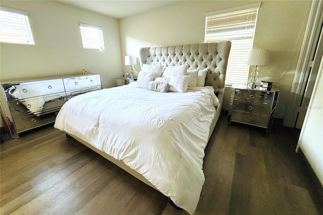 bedroom with dark wood-type flooring