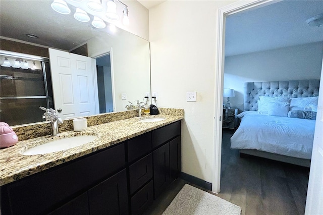 bathroom with hardwood / wood-style floors, dual sinks, and large vanity