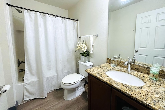 full bathroom featuring wood-type flooring, shower / tub combo with curtain, large vanity, and toilet