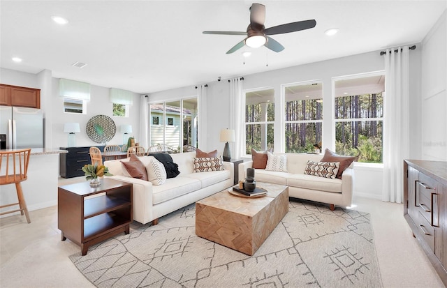 carpeted living room featuring ceiling fan