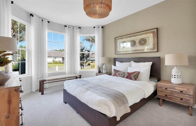 bedroom with carpet and multiple windows