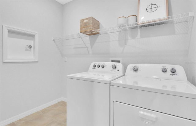 washroom with independent washer and dryer and light tile floors