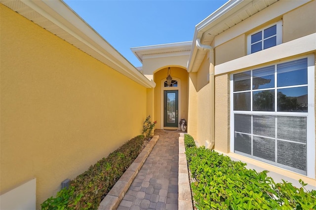 property entrance with stucco siding