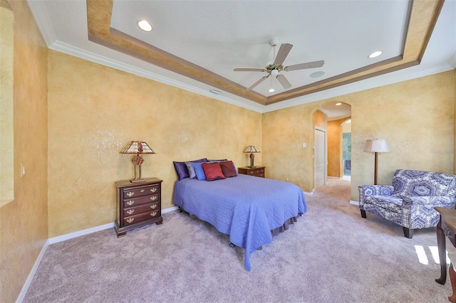 bedroom featuring arched walkways, carpet floors, a tray ceiling, and ornamental molding