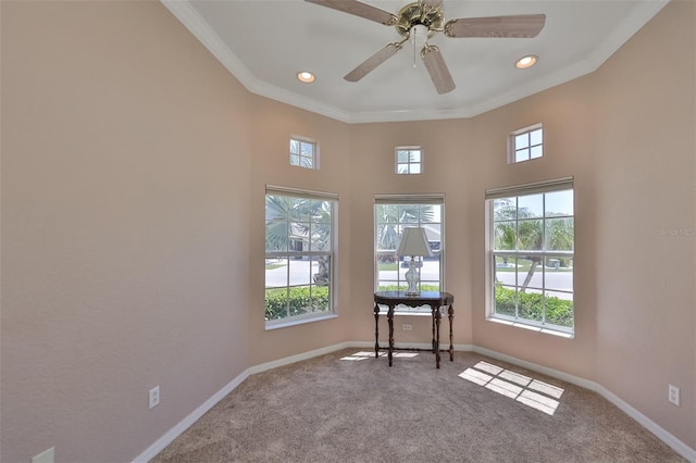 carpeted spare room with plenty of natural light, baseboards, and ornamental molding