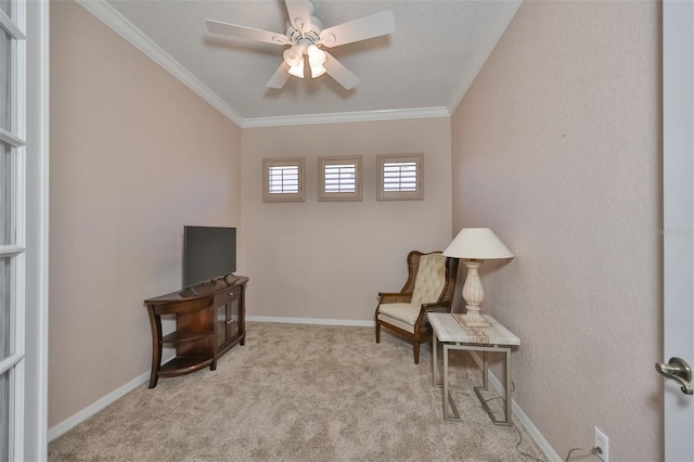 living area with a ceiling fan, carpet flooring, crown molding, and baseboards