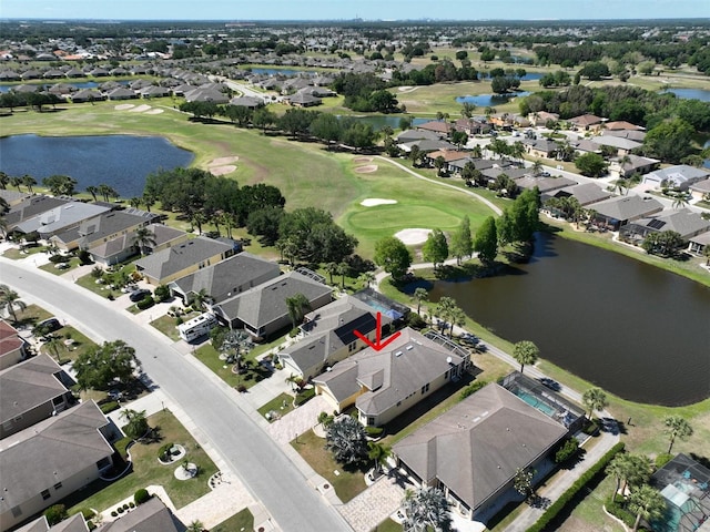 birds eye view of property featuring view of golf course, a water view, and a residential view