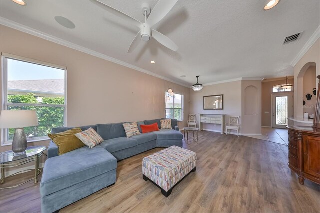 living room with plenty of natural light, wood finished floors, and visible vents