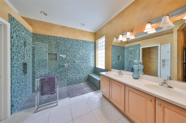 bathroom with ornamental molding, a sink, a shower stall, and tile patterned floors