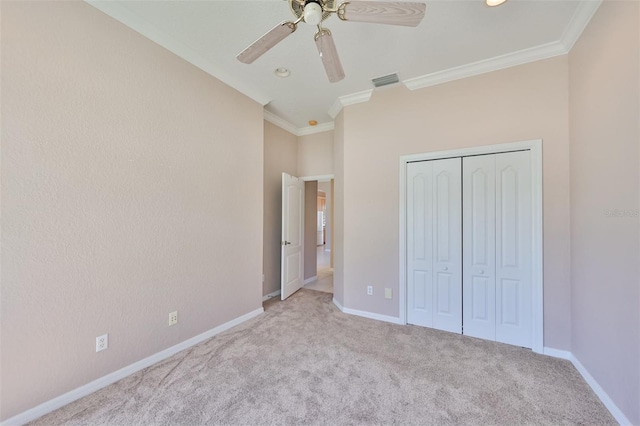 unfurnished bedroom featuring ornamental molding, visible vents, carpet floors, and baseboards