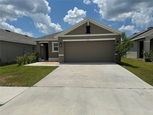 view of front of house with a front yard and a garage