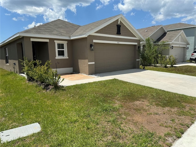 view of front of home featuring a front lawn and a garage