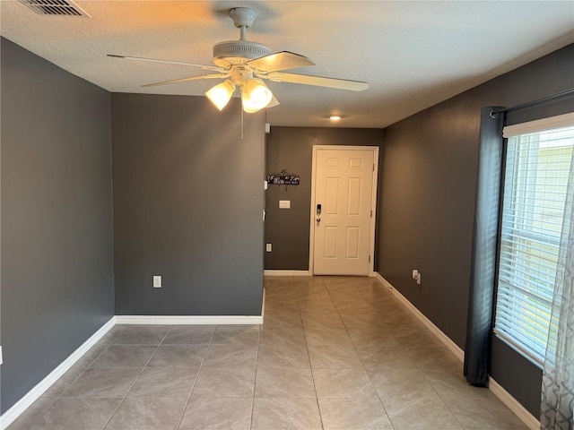 unfurnished room featuring ceiling fan and tile floors