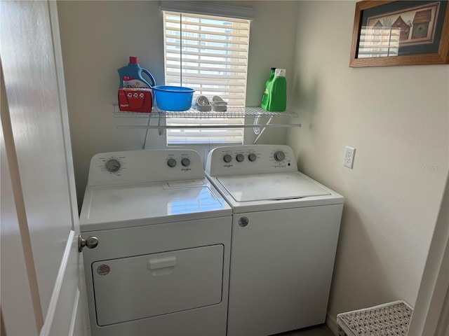 clothes washing area featuring washer and clothes dryer