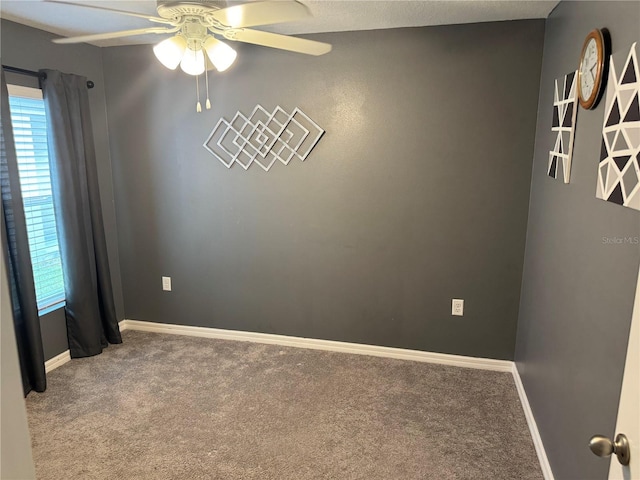 empty room featuring a healthy amount of sunlight, ceiling fan, and carpet