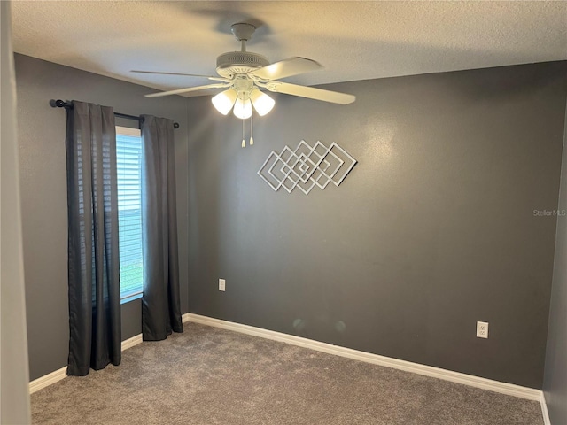 carpeted spare room with a wealth of natural light, ceiling fan, and a textured ceiling