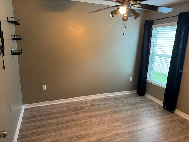 unfurnished room with wood-type flooring, plenty of natural light, and ceiling fan