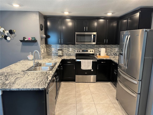 kitchen featuring light tile flooring, backsplash, sink, and stainless steel appliances