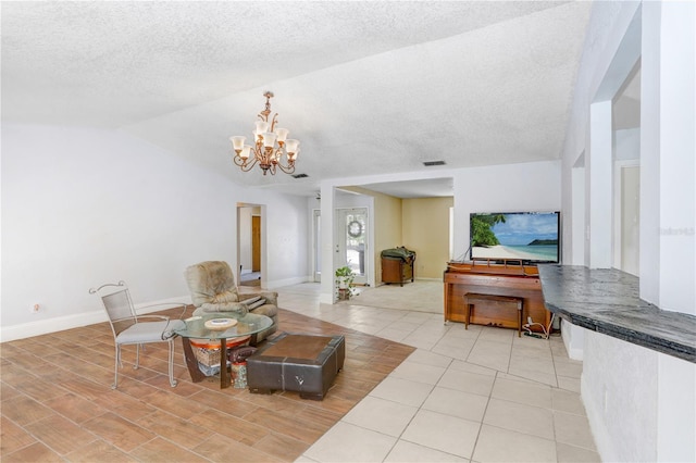 living room featuring lofted ceiling, an inviting chandelier, a textured ceiling, and light tile flooring