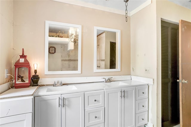 bathroom featuring crown molding and double sink vanity