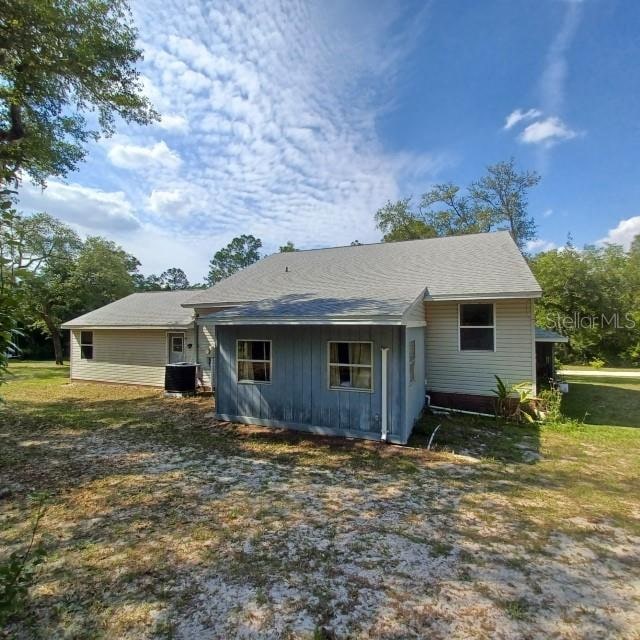 rear view of property featuring central AC