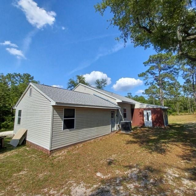 exterior space with a yard and central AC