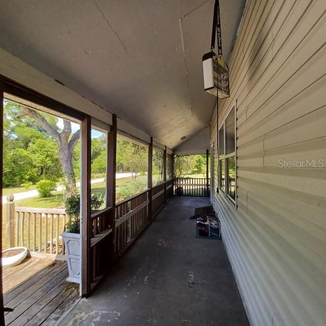 unfurnished sunroom featuring lofted ceiling