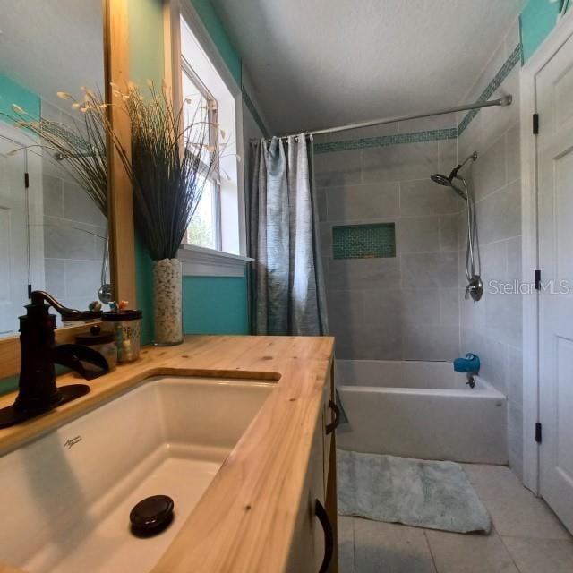 bathroom with vanity, tile patterned flooring, and shower / tub combo with curtain