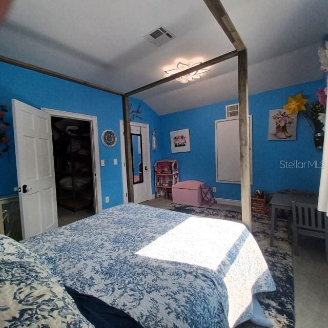 bedroom featuring vaulted ceiling