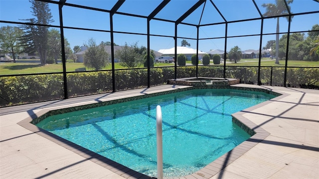 view of pool featuring glass enclosure, an in ground hot tub, and a patio area