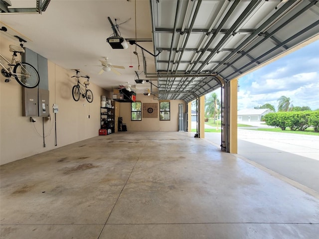 garage with a garage door opener and ceiling fan