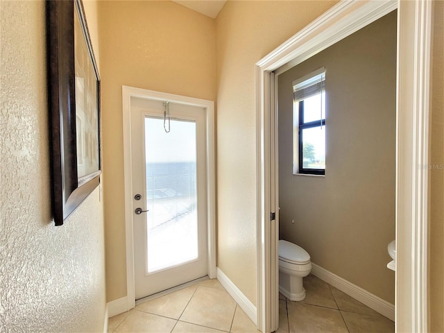 interior space with tile patterned flooring and toilet