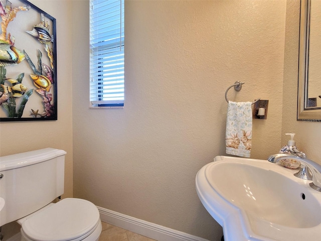 bathroom with sink, tile patterned floors, and toilet