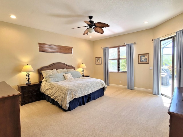 carpeted bedroom with a textured ceiling, ceiling fan, and access to exterior