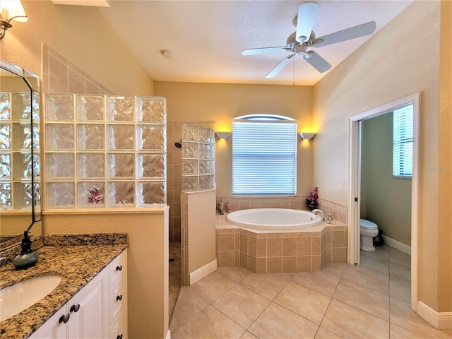 full bathroom featuring vanity, separate shower and tub, a textured ceiling, tile patterned floors, and toilet