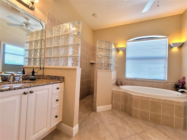 bathroom featuring tile patterned flooring, ceiling fan, independent shower and bath, and vanity