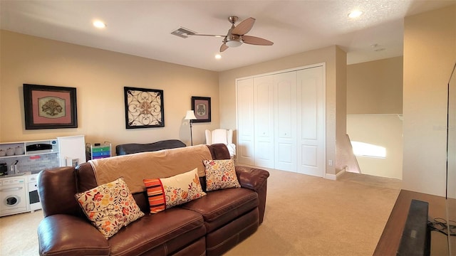 carpeted living room with ceiling fan