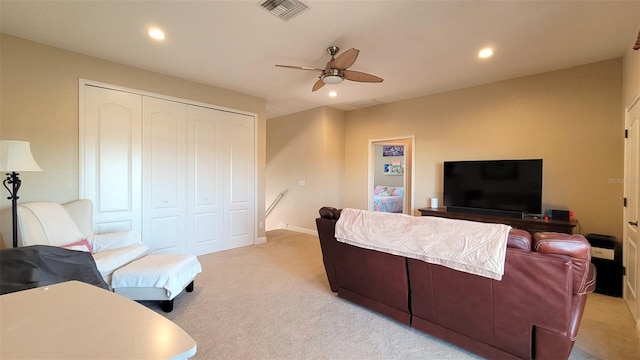 living room featuring ceiling fan and light colored carpet