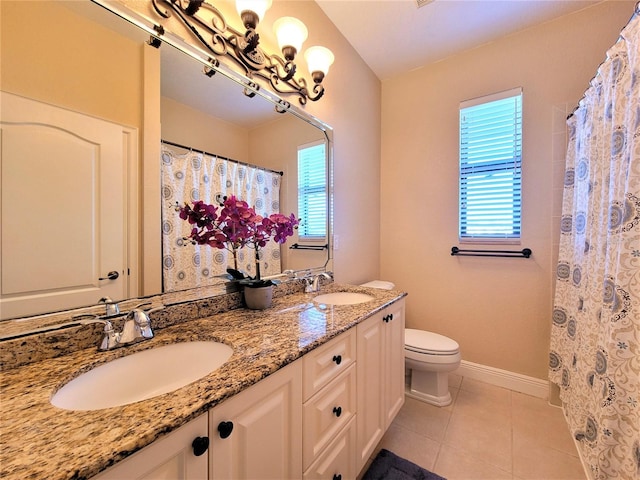 bathroom with curtained shower, vanity, toilet, and tile patterned floors