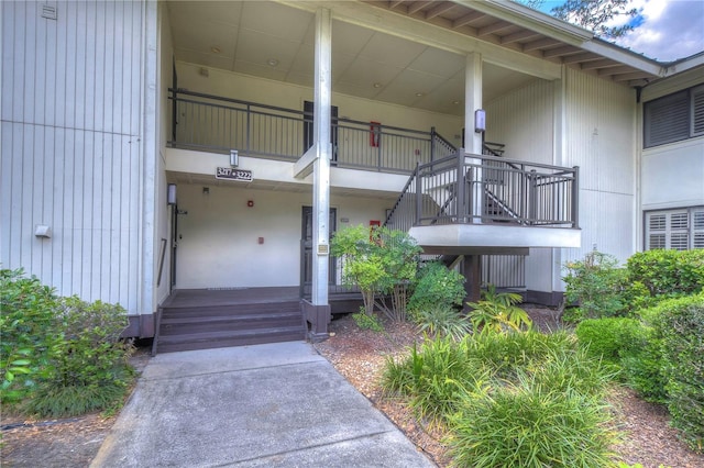 doorway to property with a porch and a balcony