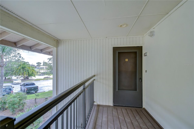 view of exterior entry with a balcony