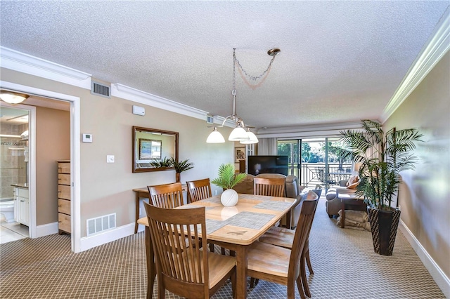 dining room featuring crown molding, carpet floors, and a textured ceiling