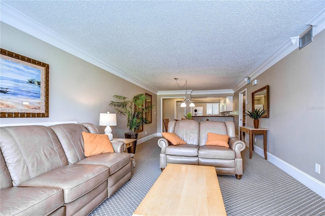 living room with ornamental molding, carpet, and a textured ceiling