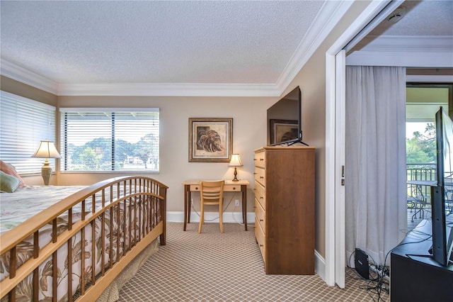 carpeted bedroom with ornamental molding and a textured ceiling