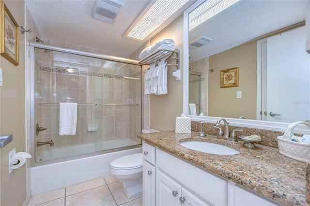 full bathroom with toilet, vanity with extensive cabinet space, enclosed tub / shower combo, tile flooring, and a textured ceiling