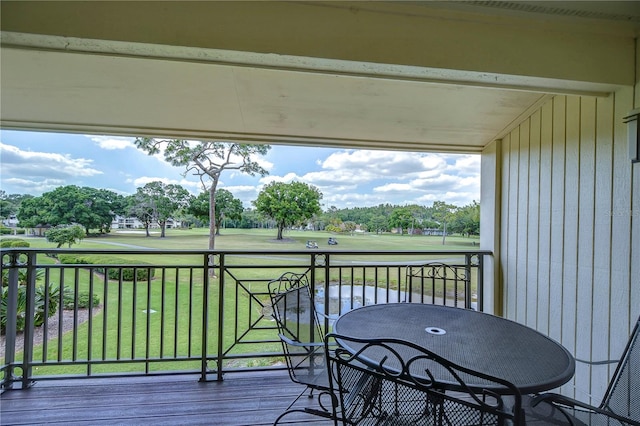 wooden deck featuring a yard